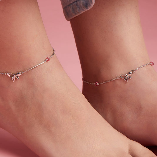 Woman wearing 925 Sterling Silver butterfly anklets with studded pink stones. Elegant women's jewelry. – Zavya