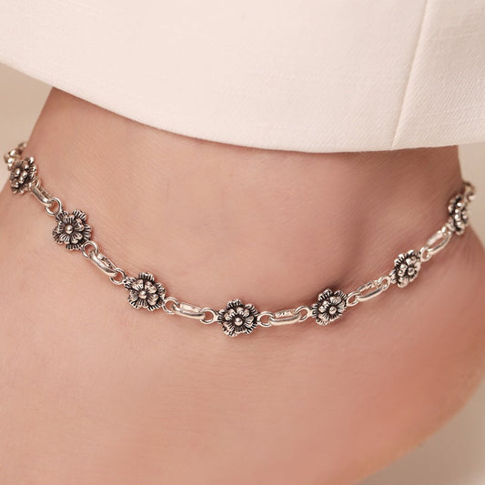 Woman wearing a floral 925 Sterling Silver anklet. Beautiful silver blossom jewellery for women – Zavya