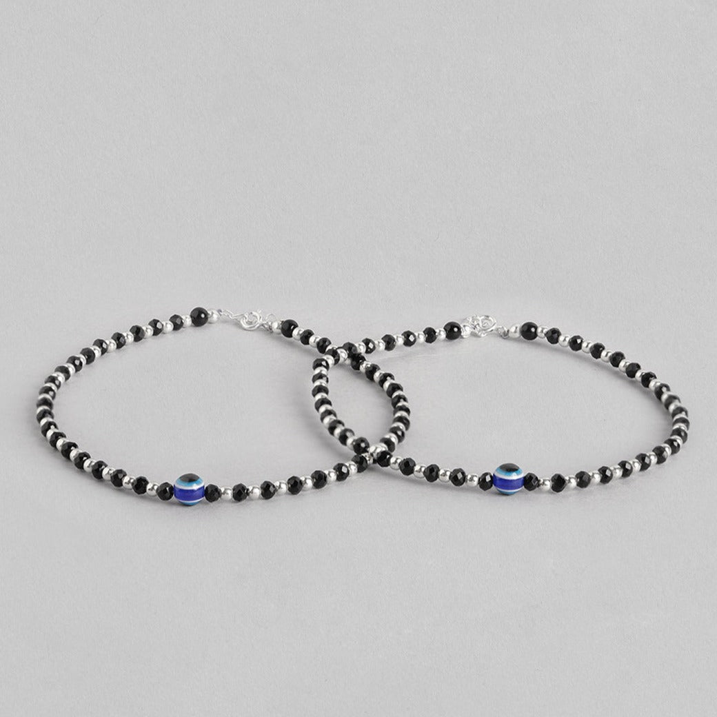 Two 925 Sterling Silver anklets for women featuring black beads and a blue evil eye. Fine jewellery – Zavya