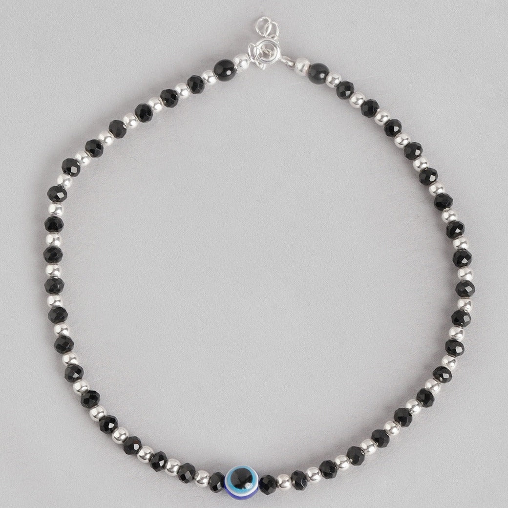 Women's 925 Sterling Silver anklet featuring alternating black beads and a blue evil eye charm. – Zavya