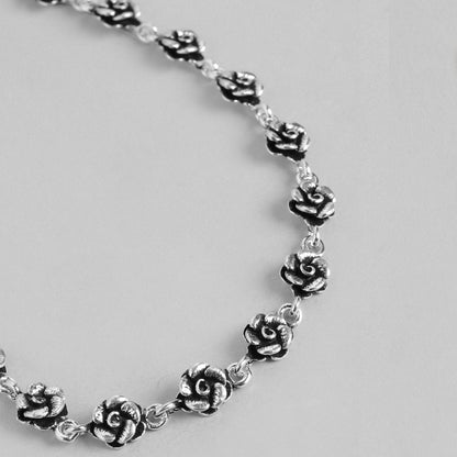 Women's 925 Sterling Silver floral anklet showing a close-up of detailed silver rose chain jewelry. – Zavya