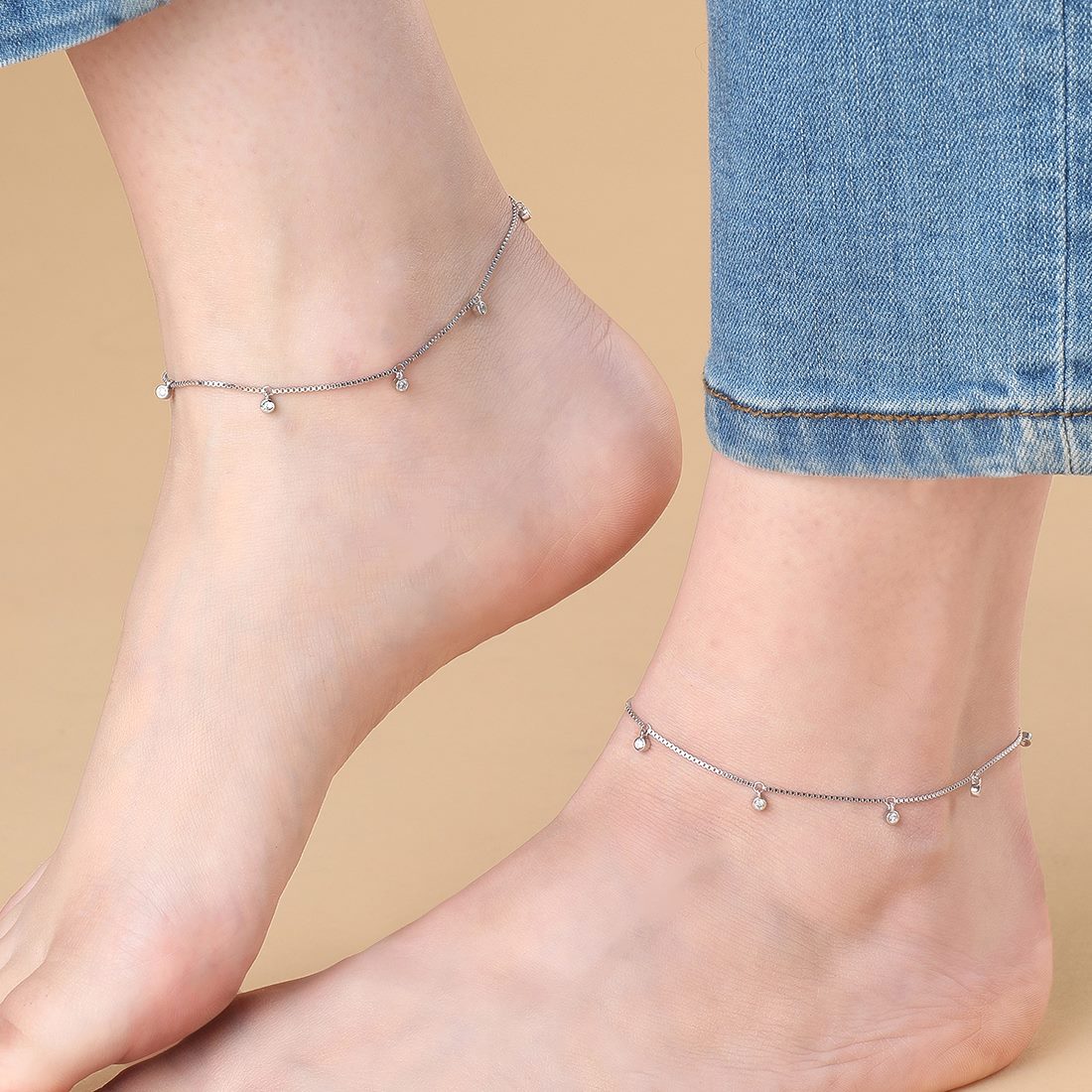 Woman wearing delicate 925 Sterling Silver anklets with CZ drops. Silver jewelry for women – Zavya