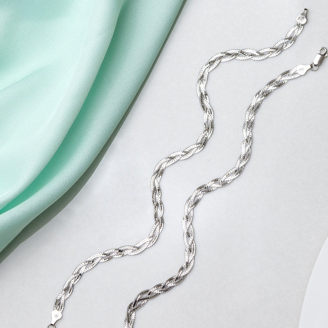 Entangled 925 Sterling Silver anklet for women. Braided chain jewellery beside mint fabric – Zavya