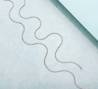 Wavy minimal chain 925 Sterling Silver anklet for women. Delicate everyday silver jewellery on light blue – Zavya