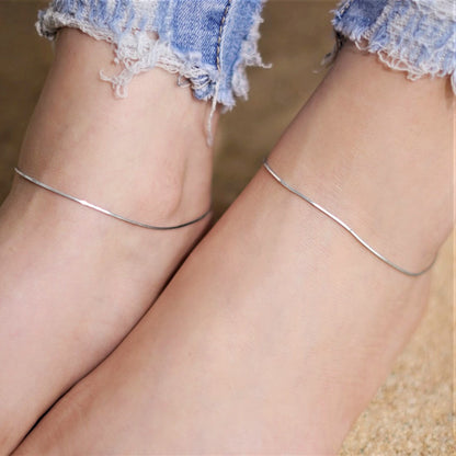 Woman wearing classic 925 Sterling Silver rope chain anklets with jeans. Minimalist women's jewellery – Zavya