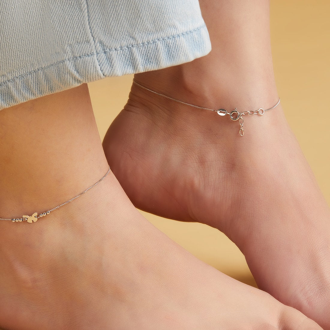 Woman wearing minimalist butterfly 925 Sterling Silver anklets. Delicate silver jewellery for women – Zavya