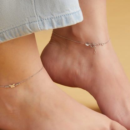 Woman wearing minimalist butterfly 925 Sterling Silver anklets. Delicate silver jewellery for women – Zavya