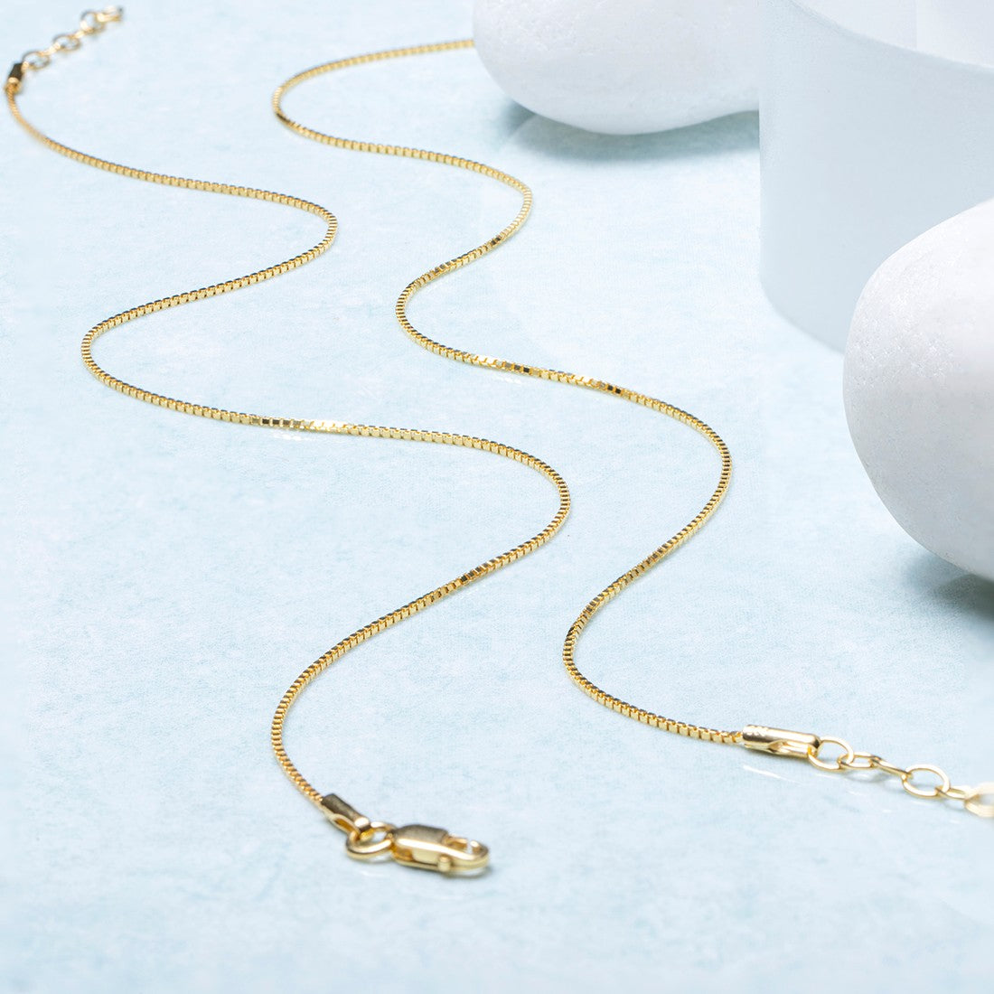 Everyday gold-plated 925 Sterling Silver box chain anklet for women on a light blue surface – Zavya