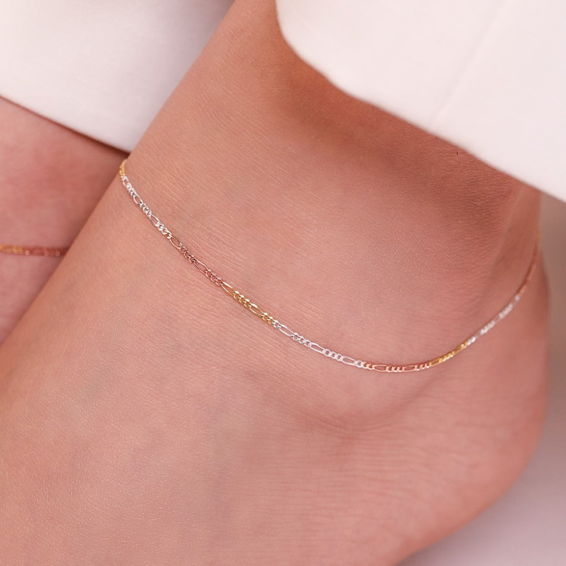Minimal triple tone figaro chain 925 sterling silver anklet delicately worn on a woman's ankle. – Zavya