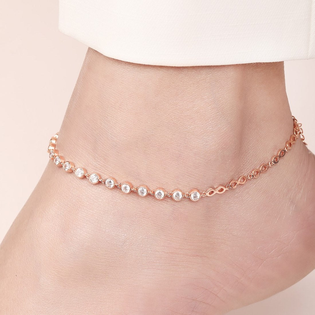Rose gold plated 925 Sterling Silver anklet with clear crystals on a woman's ankle. Women's jewellery – Zavya