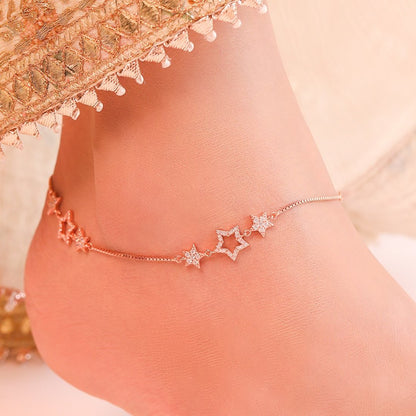 Woman wearing a rose gold plated 925 Sterling Silver anklet with cubic zirconia star charms. Women's jewelry – Zavya