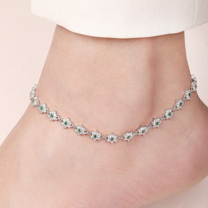 Floral green CZ 925 Sterling Silver anklet worn on a woman's ankle. Fine silver jewellery for women – Zavya