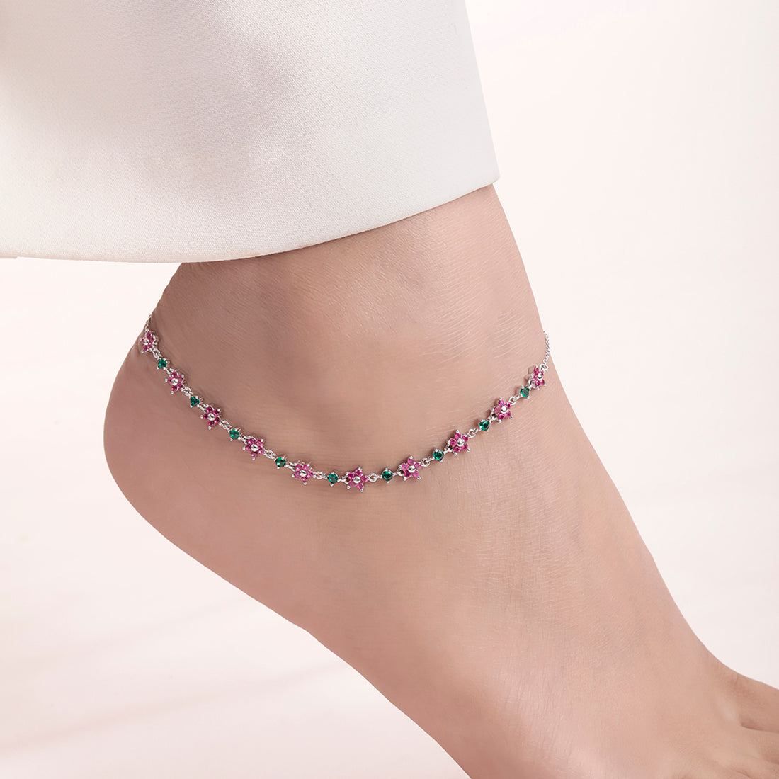 Woman wearing a pink and green floral 925 Sterling Silver anklet. Silver jewellery for women – Zavya