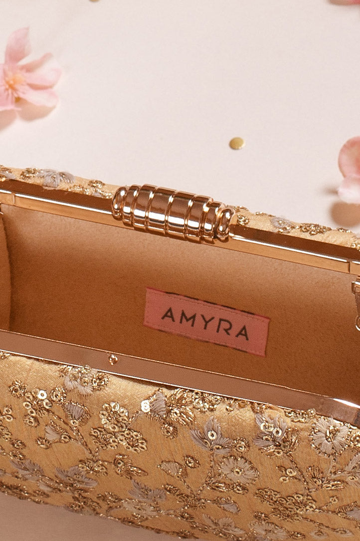 AMYRA - Elan gold capsule clutch