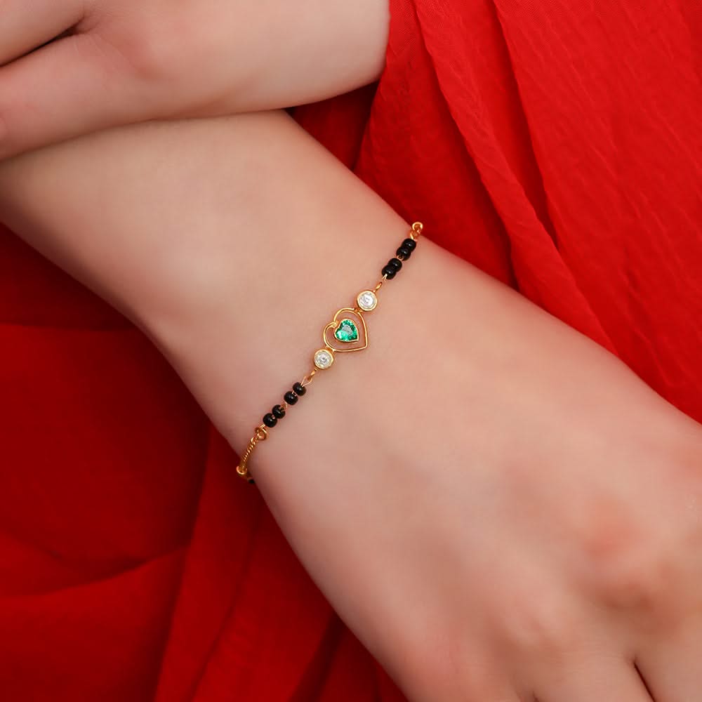 Handcrafted silver anklet with detailed floral elements, photographed on a dark background, part of Unniyarcha’s traditional collection
