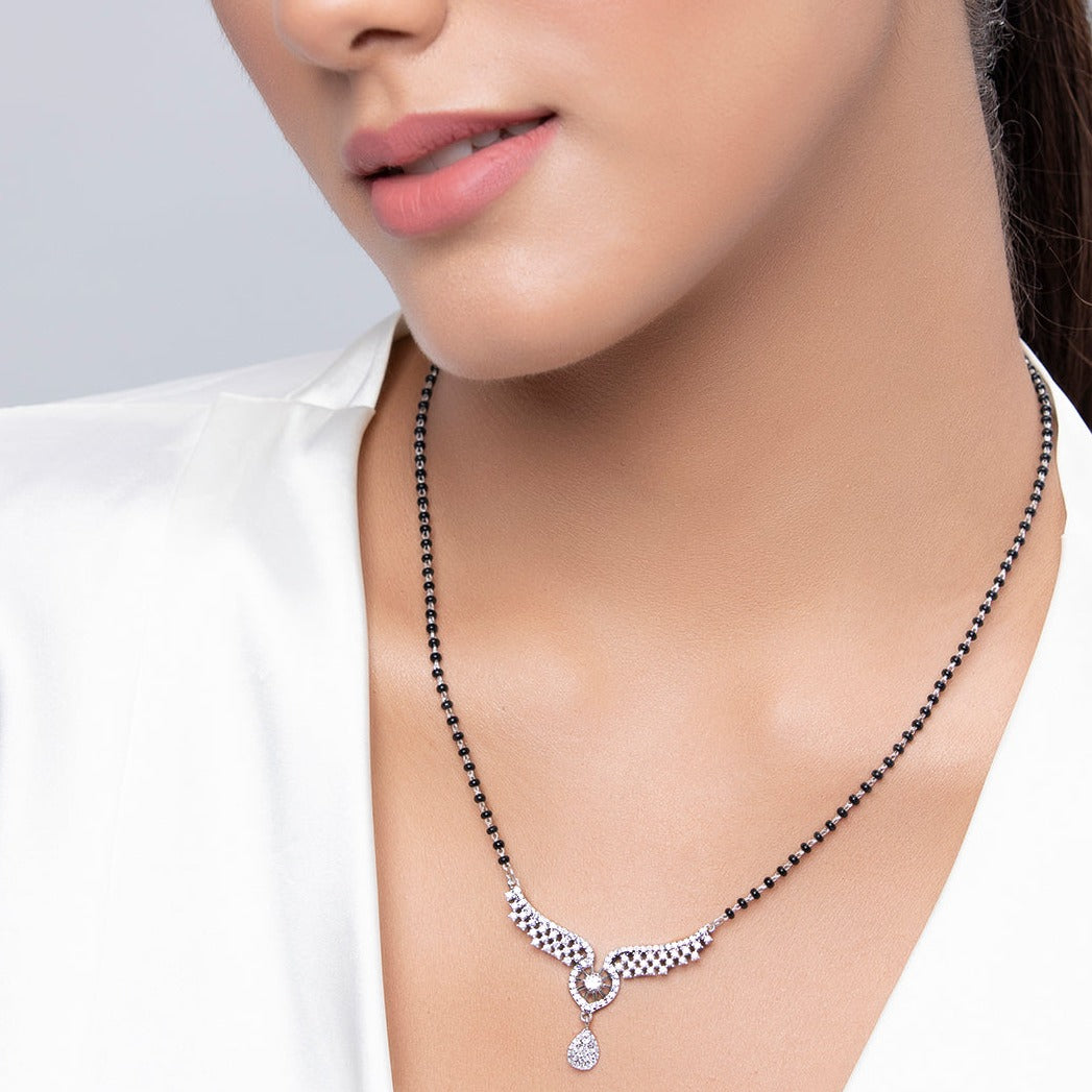 Woman wearing a 925 Sterling Silver angel wings mangalsutra necklace with black beads. Women's jewellery. – Zavya