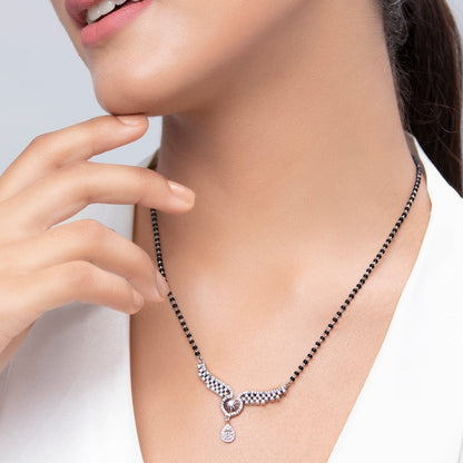 Woman wearing a 925 Sterling Silver angel wings mangalsutra necklace with black beads and pendant. – Zavya