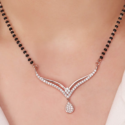 Woman wearing a 925 Sterling Silver mangalsutra necklace with black beads and sparkling drop pendant – Zavya
