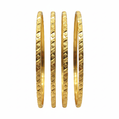 Four gold bangles on white background
