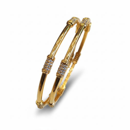 Gold bangles on white background