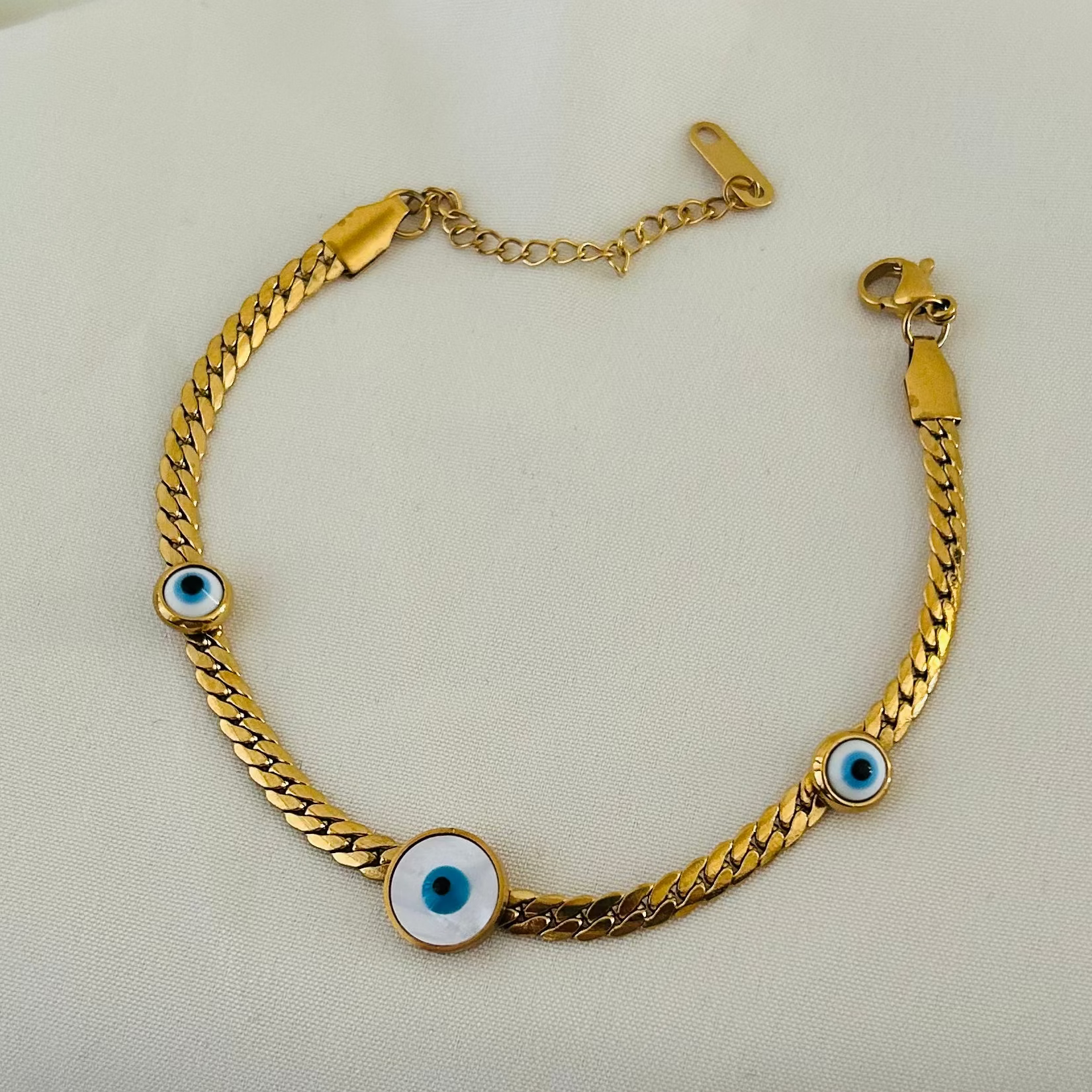 Gold bracelet with blue evil eye charms