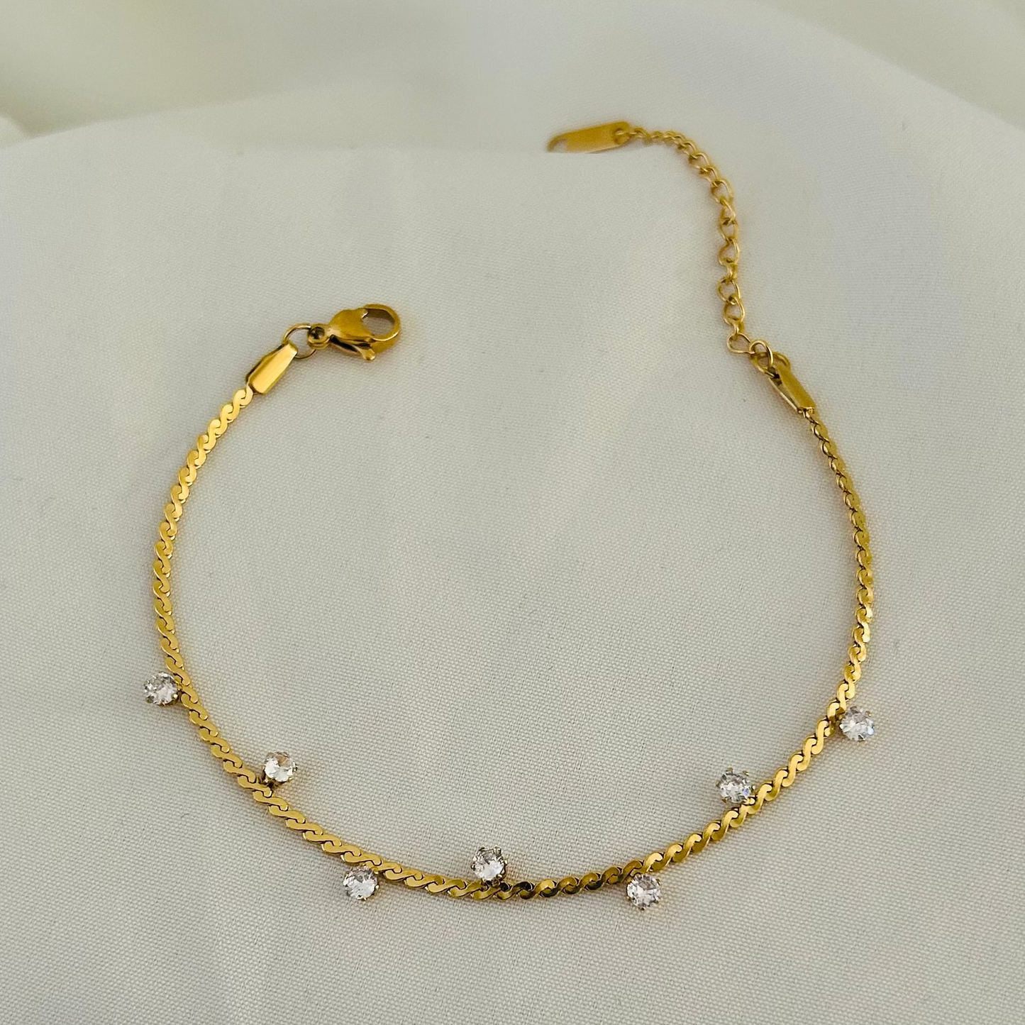 Gold bracelet with small hanging crystals