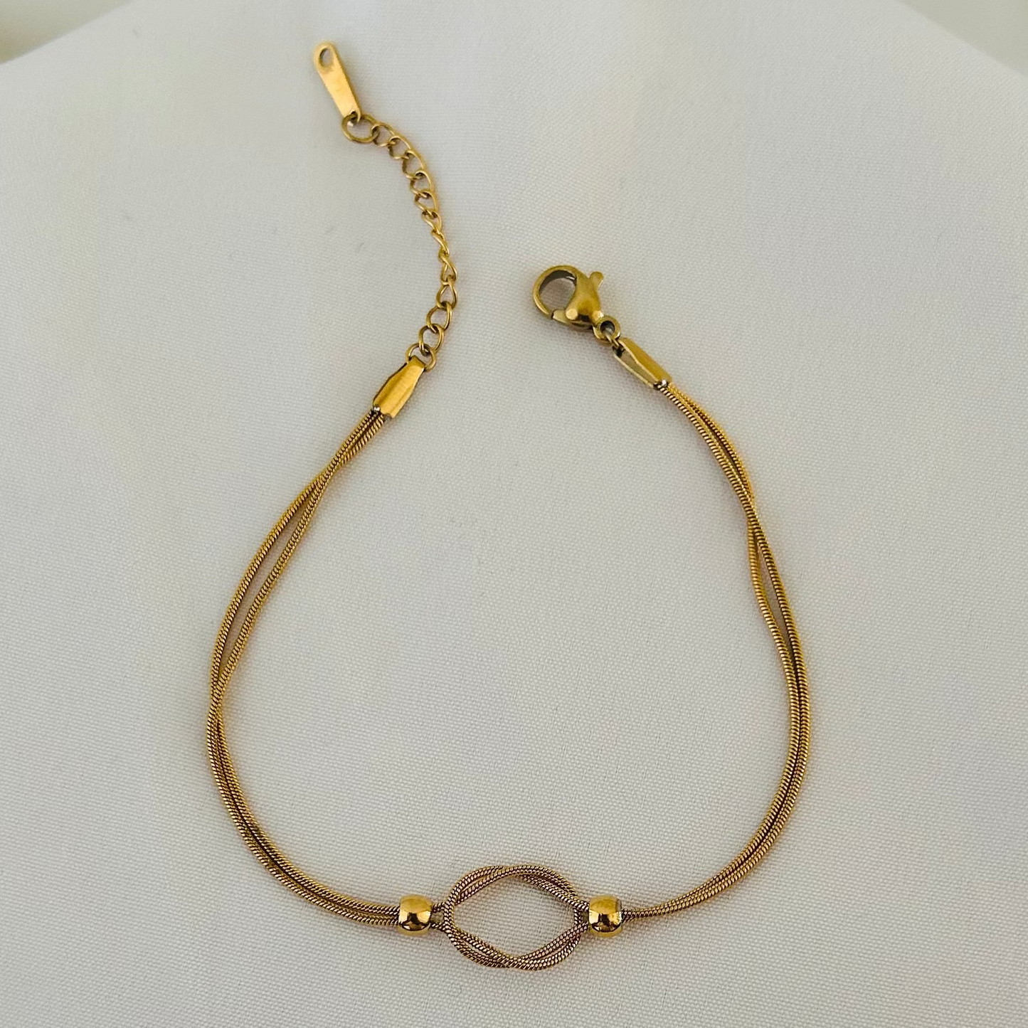 Gold bracelet with infinity symbol centerpiece