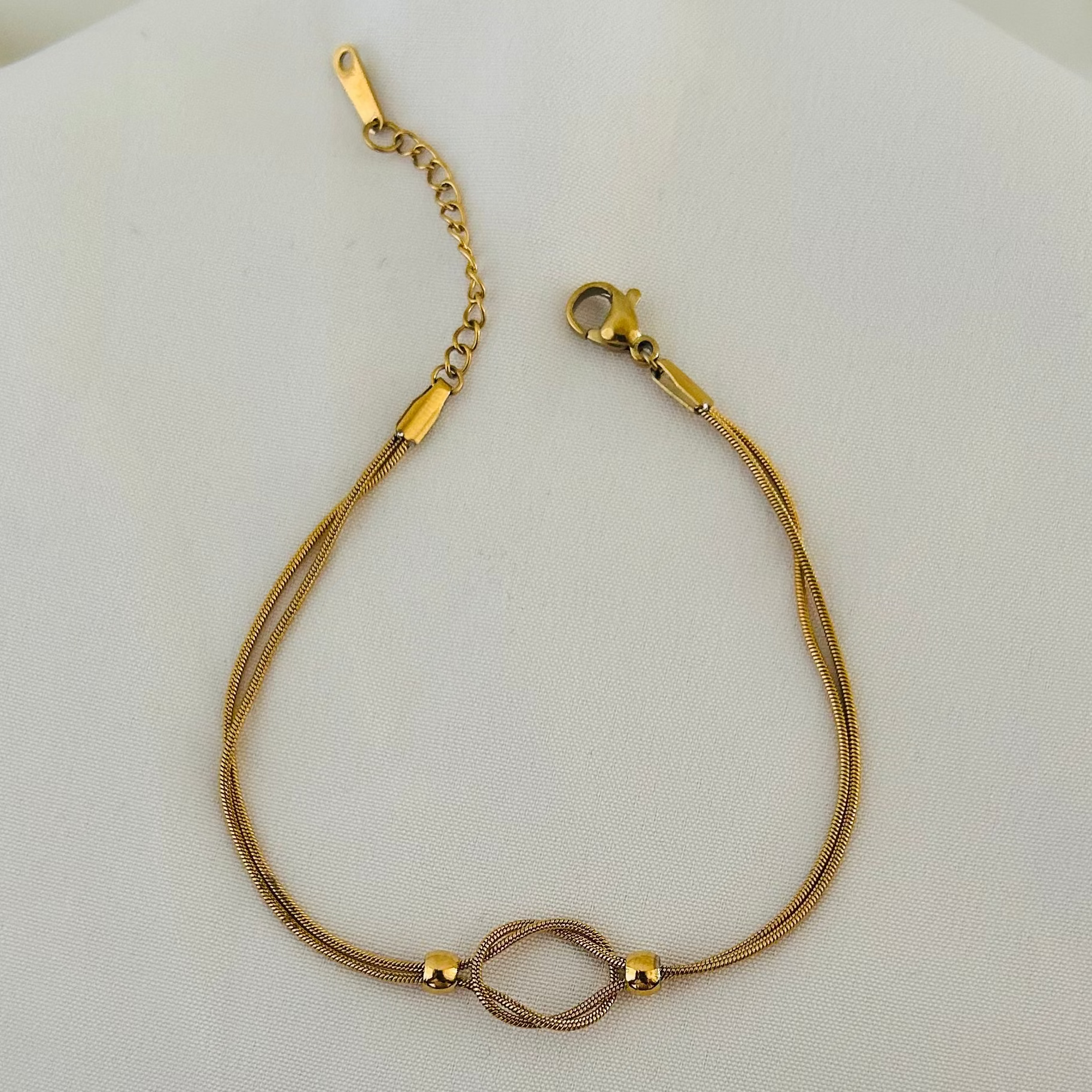 Gold bracelet with infinity symbol centerpiece