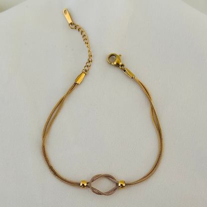 Gold bracelet with infinity symbol centerpiece