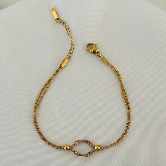 Gold bracelet with infinity symbol centerpiece