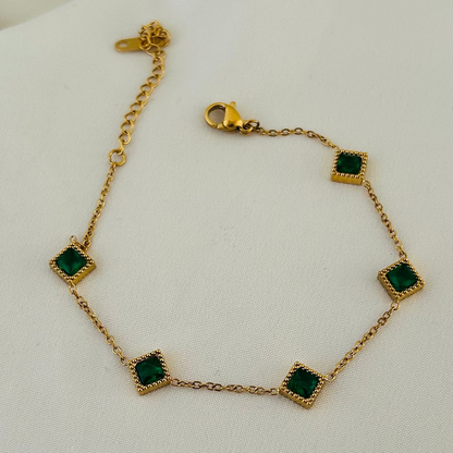 Gold bracelet with green square stones