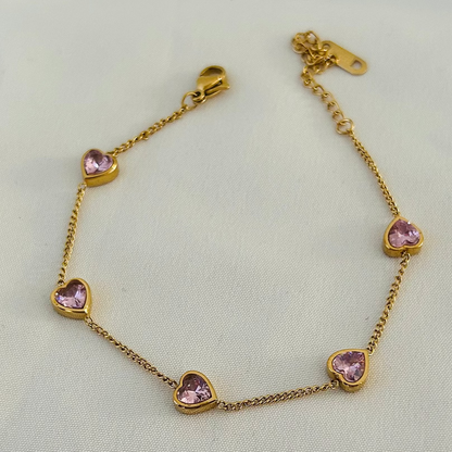 Gold bracelet with pink heart-shaped stones